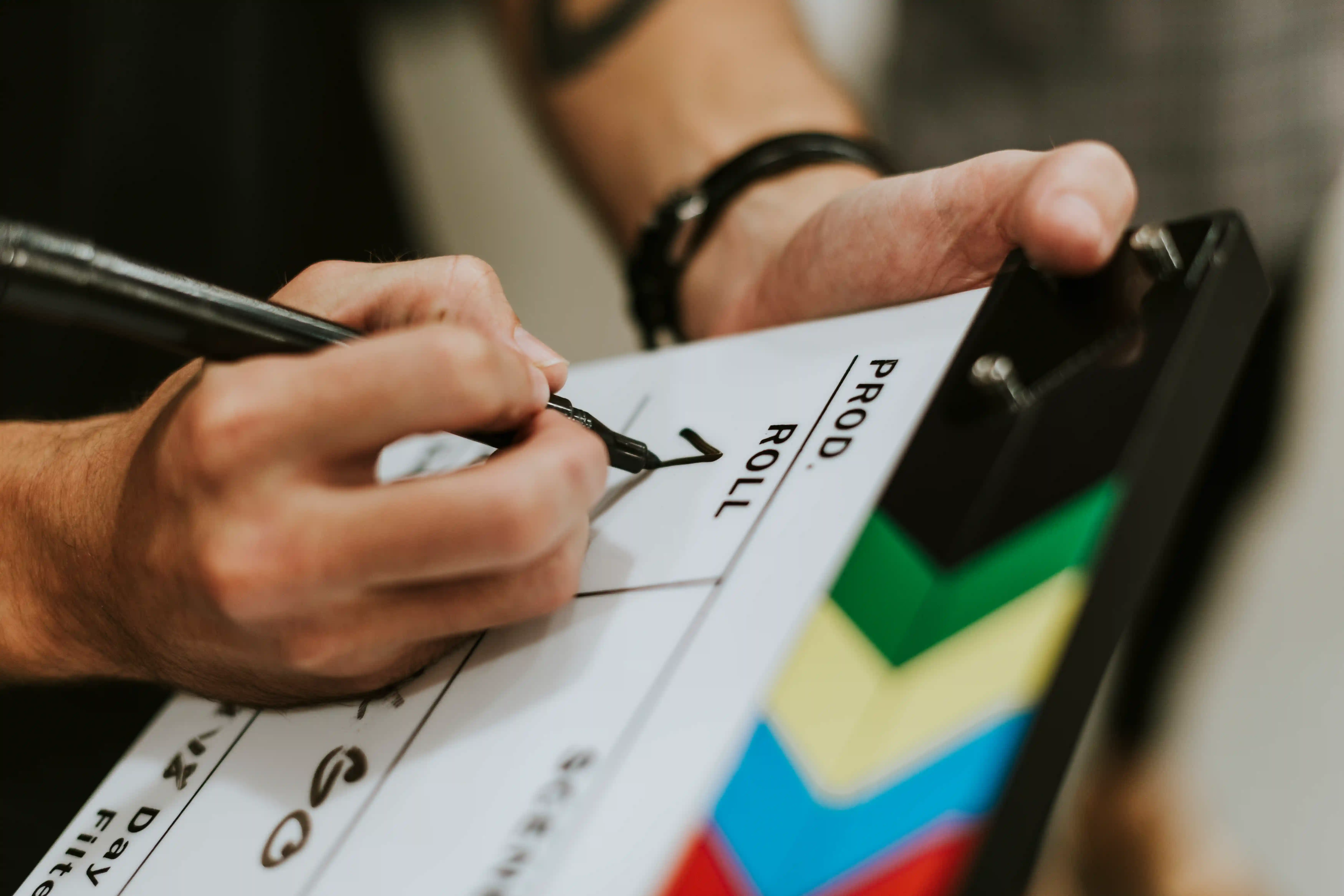 Detalle de manos organizando una escena de rodaje, representando la eficiencia en el transporte y logística cinematográfica.